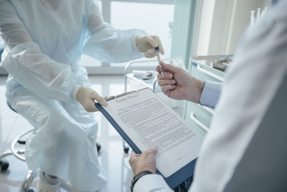 A clinician reviewing insurance paperwork with a patient